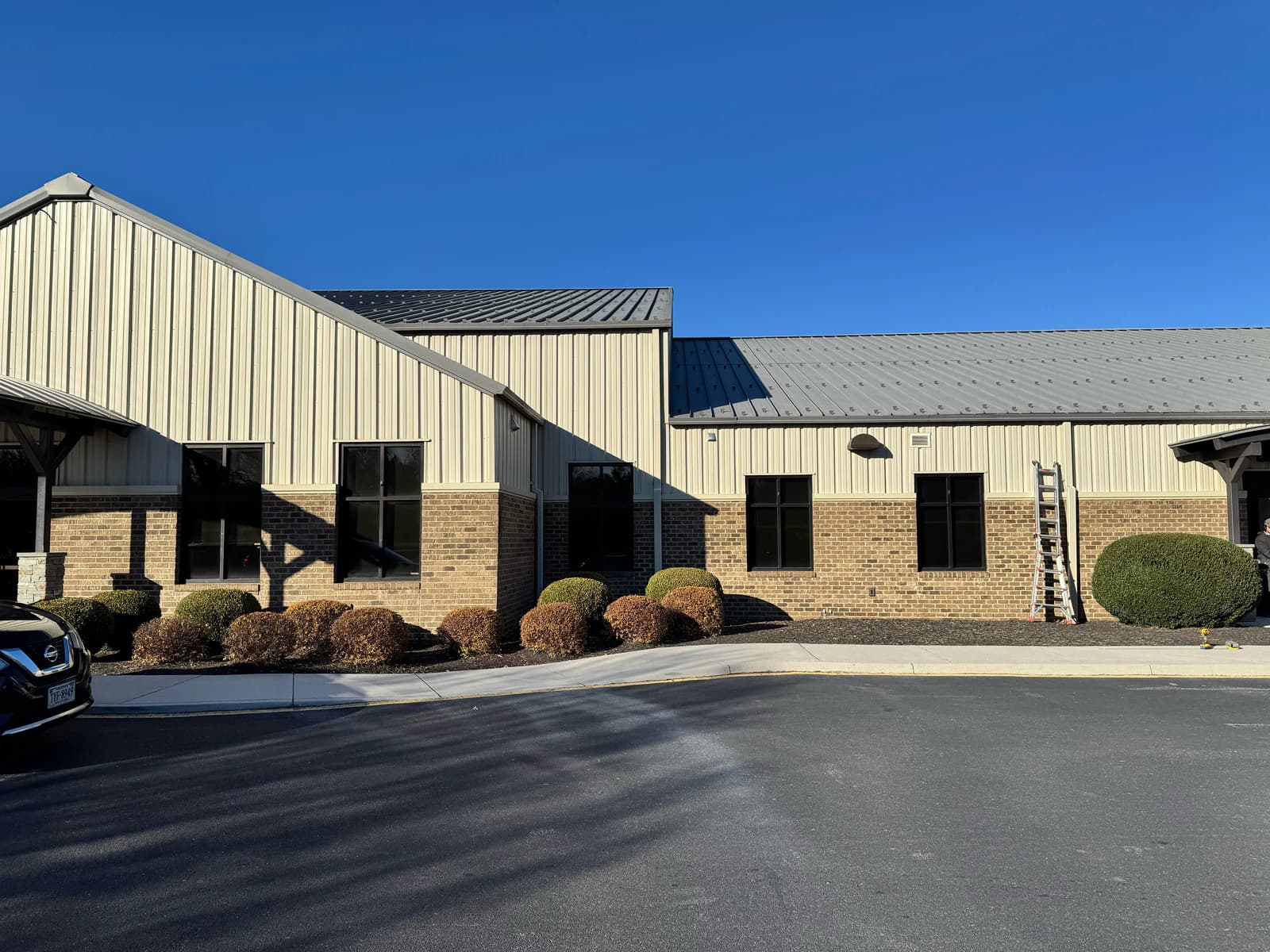 Multiple black SoundTube speakers distributed along the Life Co exterior elevation