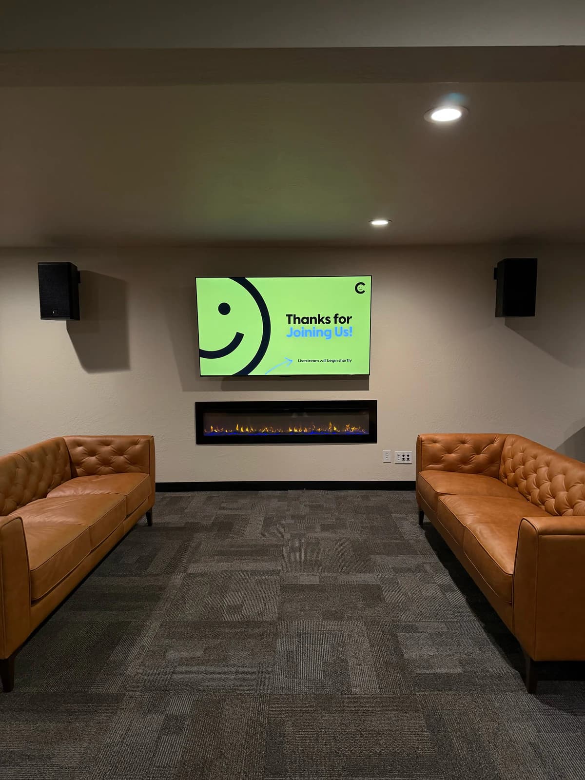 Joy Church lobby display centered between two RCF loudspeakers