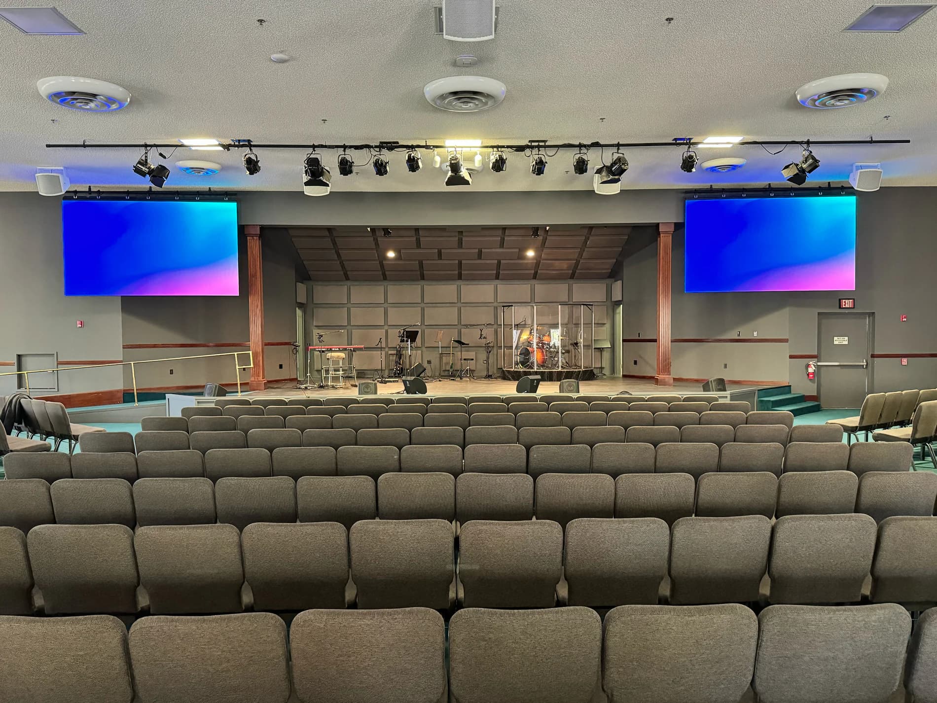Centered view of both MountainHouse LED screens from the sanctuary seating